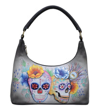 Load image into Gallery viewer, Anuschka style 371, handpainted Medium Zip Top Hobo. Calaveras de Azucar Painted in Grey Color. Featuring Inside zippered wall pocket two multipurpose pockets and rear zip pocket.
