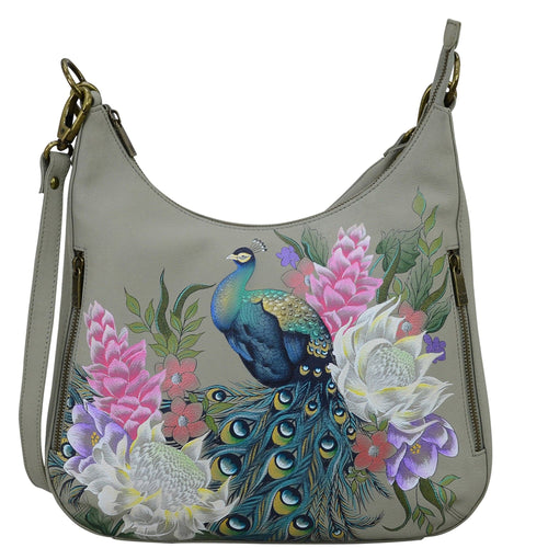 Anuschka style 662, handpainted Convertible Slim Hobo With Crossbody Strap. Regal Peacock Painted in Grey Color. Featuring inside zippered wall pocket, one open wall pocket, two multipurpose pockets with gusset and rear full length zippered pocket, slip in cell pocket.