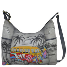 Load image into Gallery viewer, Anna by Anuschka style 8082, handpainted Large Shoulder Hobo. Happy Camper painting in grey color. Featuring two open side pockets, Fits Laptop, Fits tablet.
