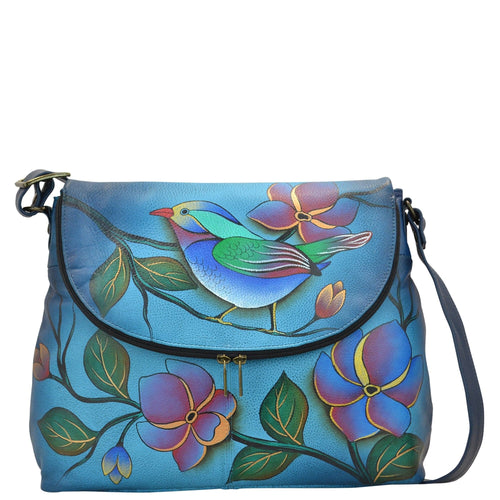 Anna by Anuschka style 8090, handpainted Large Flap Bag. Lonesome Bird Denim painting in blue color. Featuring flap opens with a magnetic snap closure to main compartment, Fits Laptop, Fits tablet, Fits E-Reader.