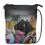 Anna by Anuschka style 8123, handpainted Mini Cross Body. Sin City painting in black color. Featuring inside full length zippered wall pocket, one cell pocket, fits phone.