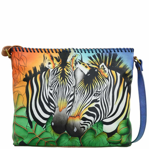 Anna by Anuschka style 8260, handpainted Shoulder Bag. Zebra Safari painting in multi color. Featuring magnetic snap button entry to main compartment, One open wall pocket, two multipurpose pockets, Fits E-Reader, Fits tablet.