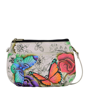 Anna by Anuschka style 8280, handpainted Small Multi Compartment Crossbody. Floral Paradise painting in white color. Featuring inside zippered wall pocket with cell and multipurpose pocket, Fits tablet, Removable strap.