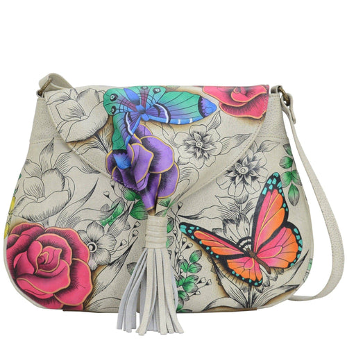 Anna by Anuschka style 8286, handpainted Flap Hobo. Floral Paradise painting in white color. Featuring one full length pocket with magnetic button under flap, Fits E-Reader, Fits tablet.