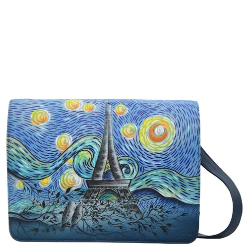 Anna by Anuschka style 8301, handpainted Medium Saddle Crossbody. Love In Paris painting in blue color. Featuring magnetic flap entry to three open compartments and two zippered compartments.