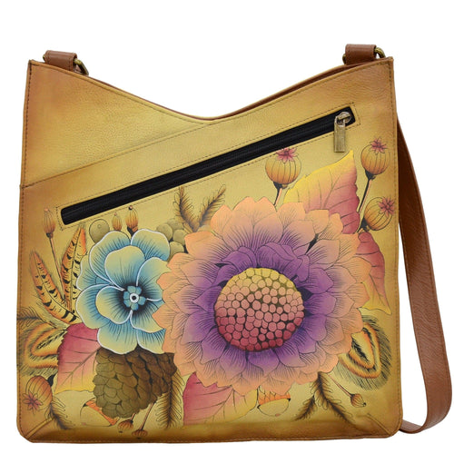 Anna by Anuschka style 8312, handpainted V Top Large Crossbody. Rustic Bouquet painting in tan color. Featuring magnetic snap button entry to main compartment, Fits E-Reader, Fits tablet, Fits Laptop.