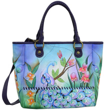 Load image into Gallery viewer, Anna by Anuschka style 8332, handpainted Large Tote. Midnight Peacock painting in blue color. Featuring double magnetic snap button entry to main compartment, inside zippered wall pocket, one open wall pocket, two multipurpose pockets, rear full length zippered pocket and slip in cell pocket.
