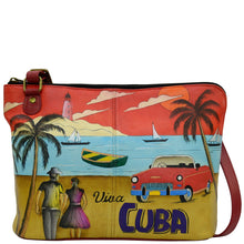 Load image into Gallery viewer, Anna by Anuschka style 8338, handpainted Two-Sided Zip Travel Organizer. Viva Cuba painting in red/wine color. Featuring inside zippered partition pocket, zippered wall pocket, open pocket and two multi-purpose pocket, ten credit card holder.
