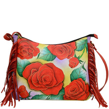 Load image into Gallery viewer, Anna by Anuschka style 8339, handpainted Large Fringed Hobo. Romantic Rose painting in red/wine color. Featuring one zippered central compartment with four pop up credit card holder and one ID window, inside one full length zippered wall pocket, one open wall pocket and two multipurpose pockets.
