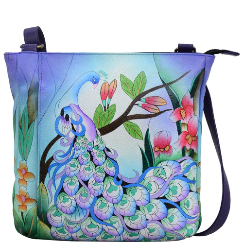 Anna by Anuschka style 8341, handpainted Medium Crossbody. Midnight Peacock painting in blue color. Featuring inside one zippered wall pocket, one open pocket, two multipurpose pockets, front zippered vertical pocket, rear full length zippered pocket and slip in cell pocket.