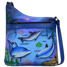 Load image into Gallery viewer, Anna by Anuschka style 8354, handpainted Assymetric Crossbody. Playful Dolphin painting in blue color. Featuring inside one zippered wall pocket, one open pocket, two multipurpose pockets and front zippered pocket.
