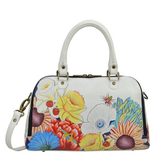 Anna by Anuschka style 8368, handpainted Wide Organizer Satchel. Floral Melody painting in white color. Featuring three gusted pocket and one zippered pocket covered in hook and loop, two card holders and one ID window and two multipurpose gusseted pockets.