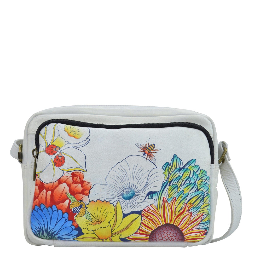 Anna by Anuschka style 8438, handpainted Messenger Crossbody. Floral Melody painted in White color. Featuring One zippered wall pocket, eight card holders and one ID window and zip pocket on back.